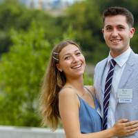 A couple posing for a photo outside.